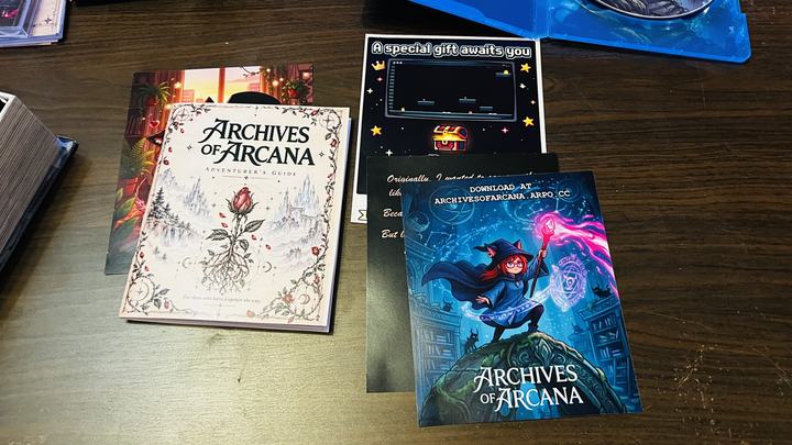 The Adventurer’s Guide manual, next to the promotional inserts